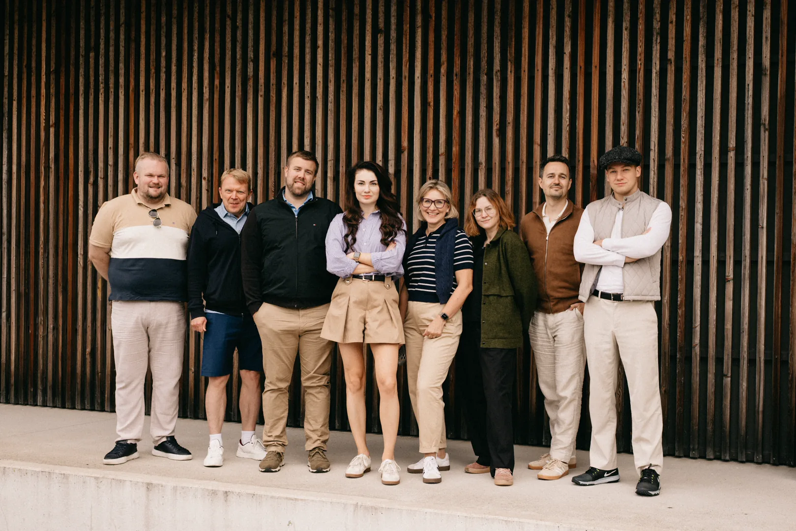 The WHAT IF team in front of a timber facade